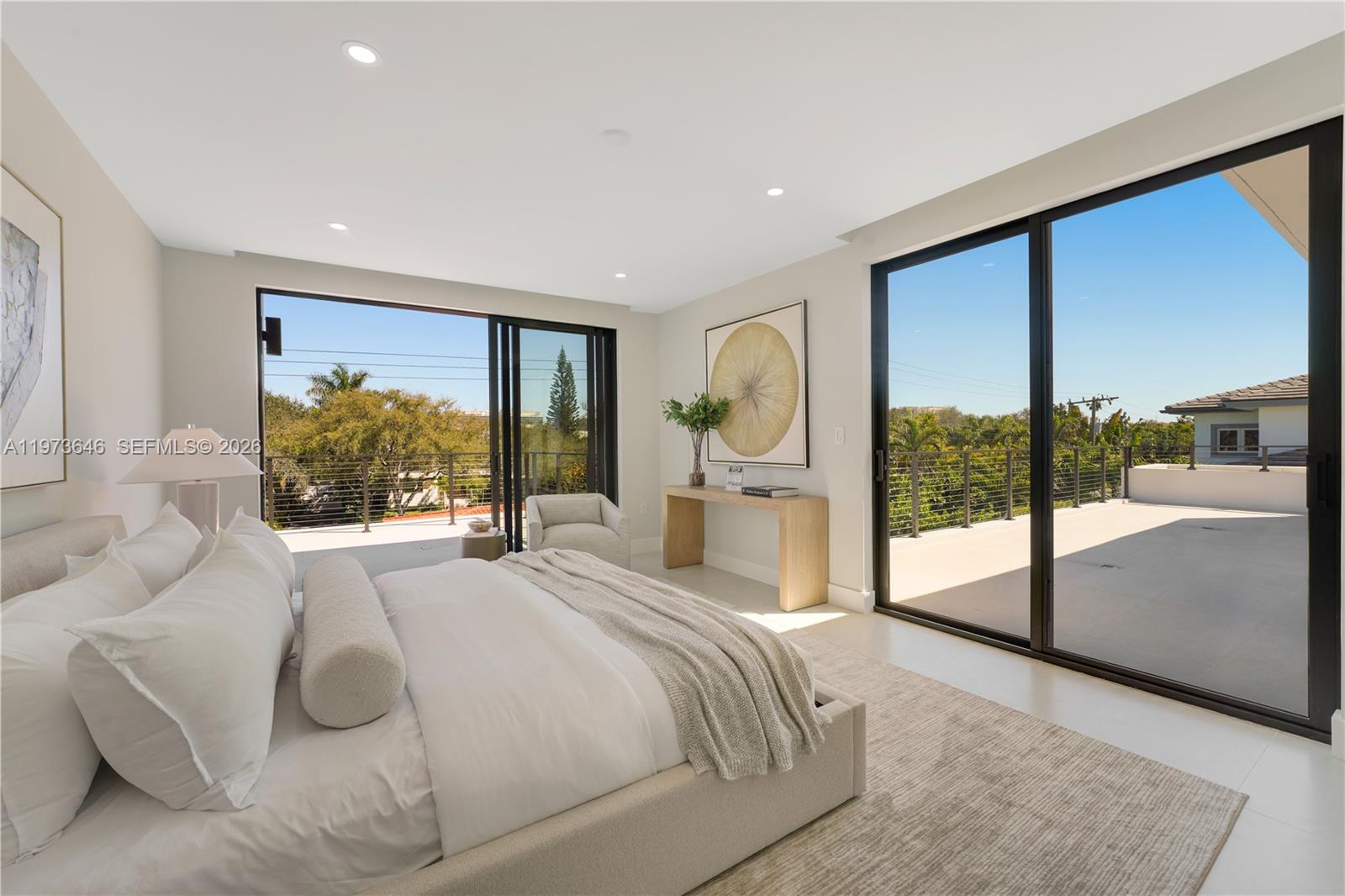 285 Woodcrest Road Key Biscayne, FL 33149 - Photo 25 of 53 a large bedroom with a large bed and a large window with outer view