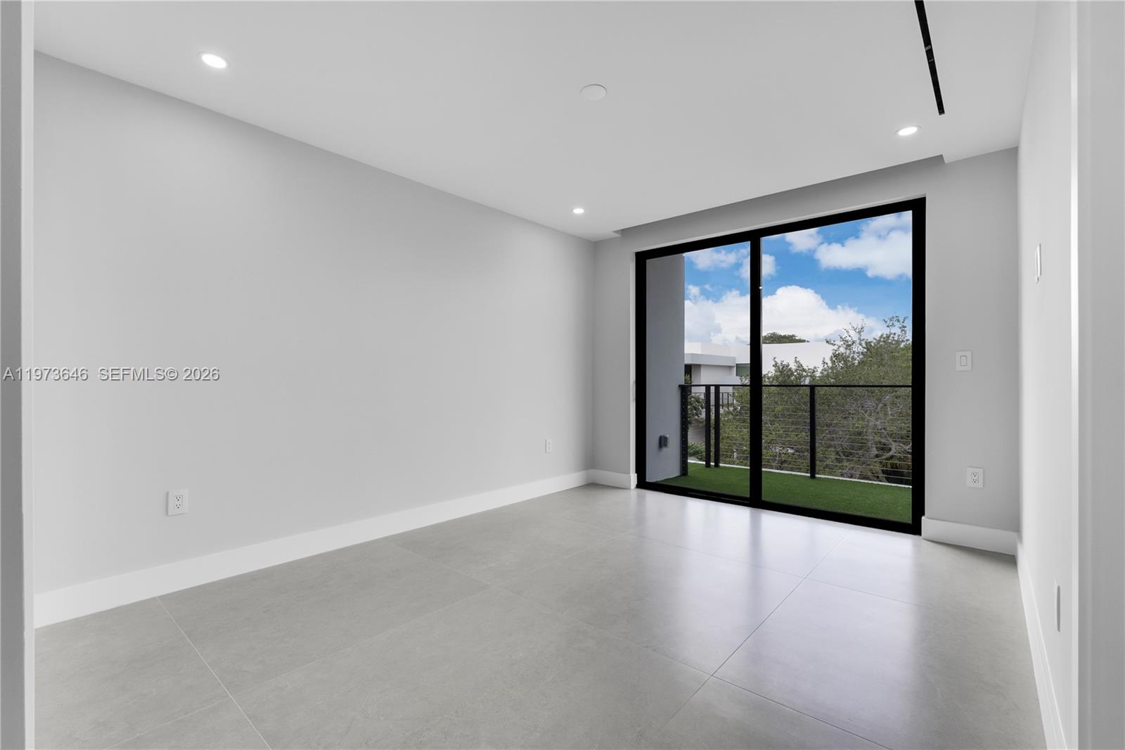 285 Woodcrest Road Key Biscayne, FL 33149 - Photo 31 of 53 an empty room with wooden floor and windows