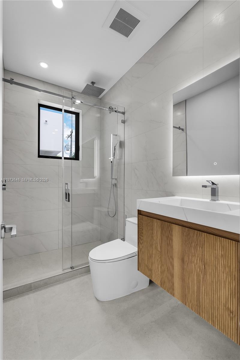 285 Woodcrest Road Key Biscayne, FL 33149 - Photo 34 of 53 a bathroom with a sink a toilet and shower