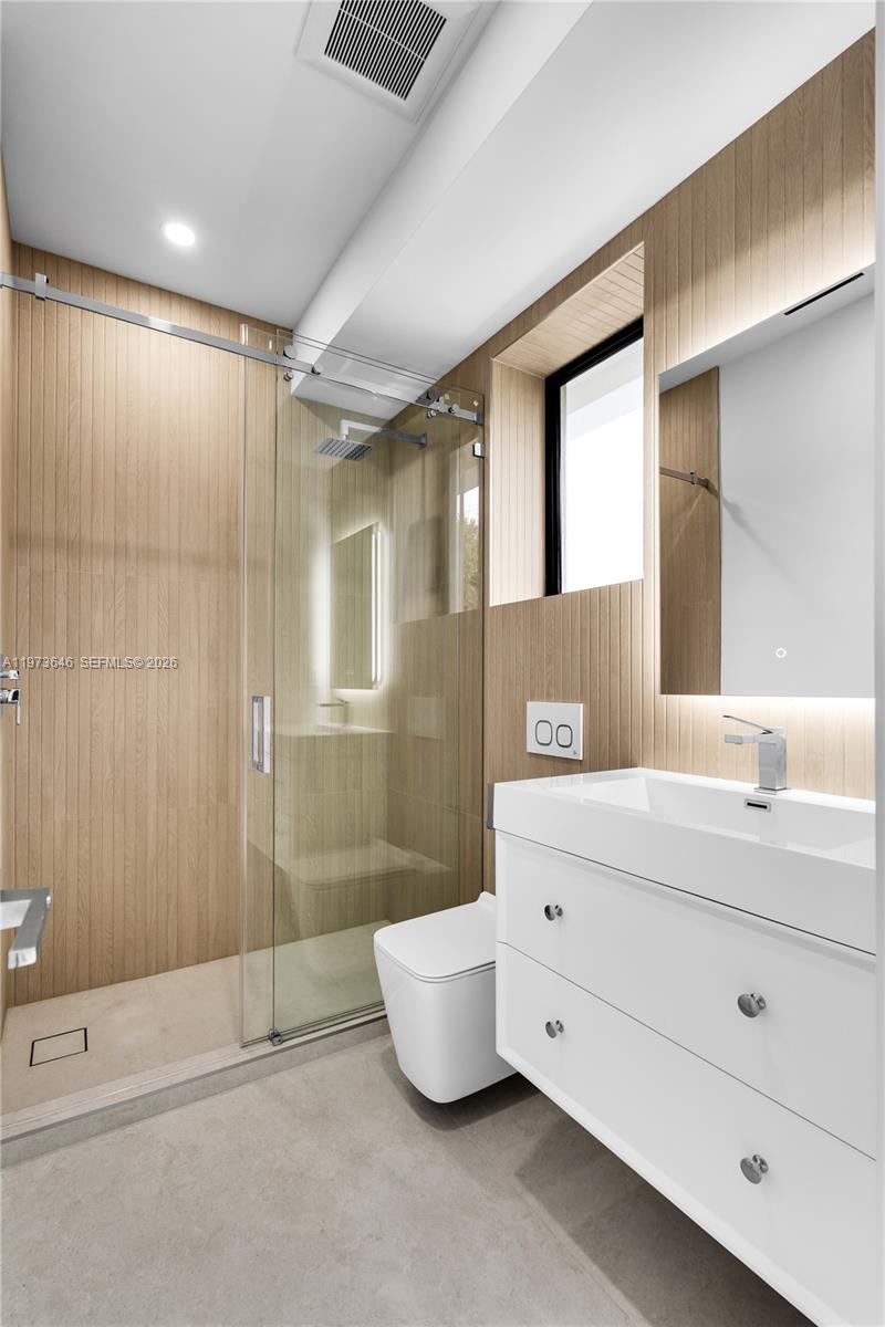 285 Woodcrest Road Key Biscayne, FL 33149 - Photo 35 of 53 a bathroom with a toilet sink and shower