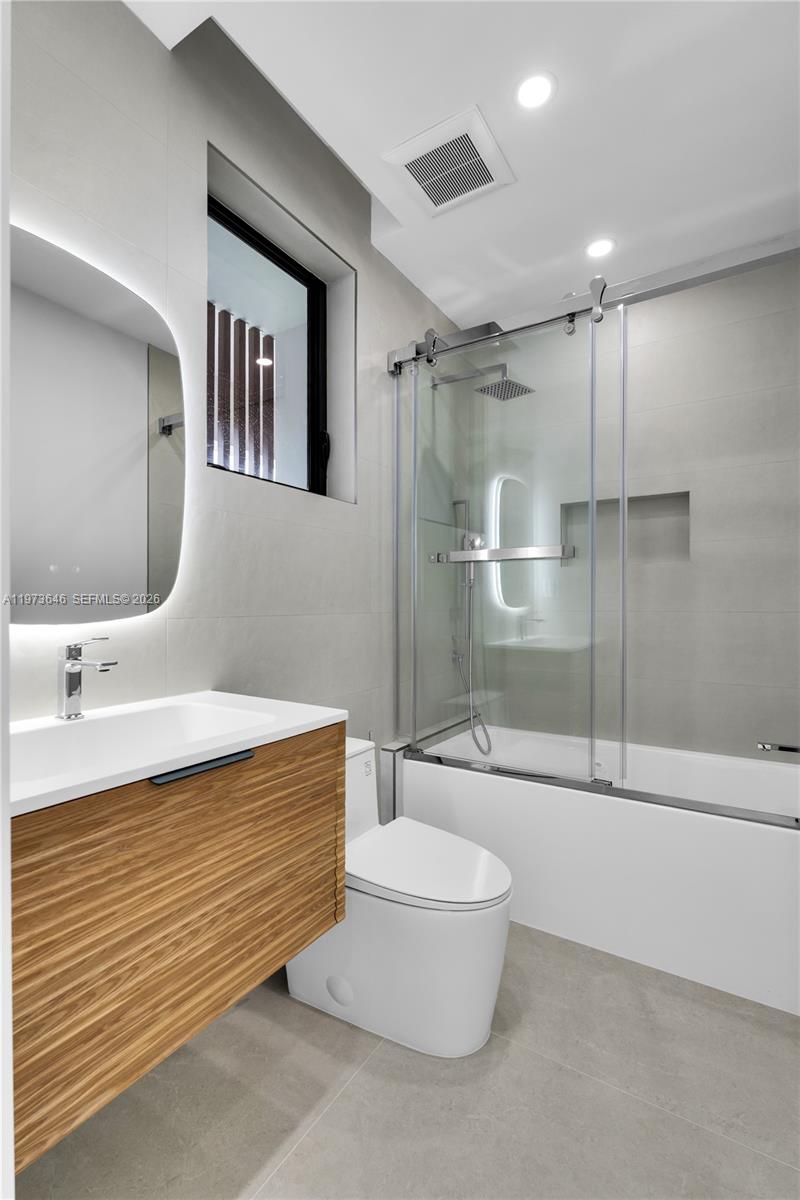 285 Woodcrest Road Key Biscayne, FL 33149 - Photo 37 of 53 a bathroom with a sink a toilet and shower