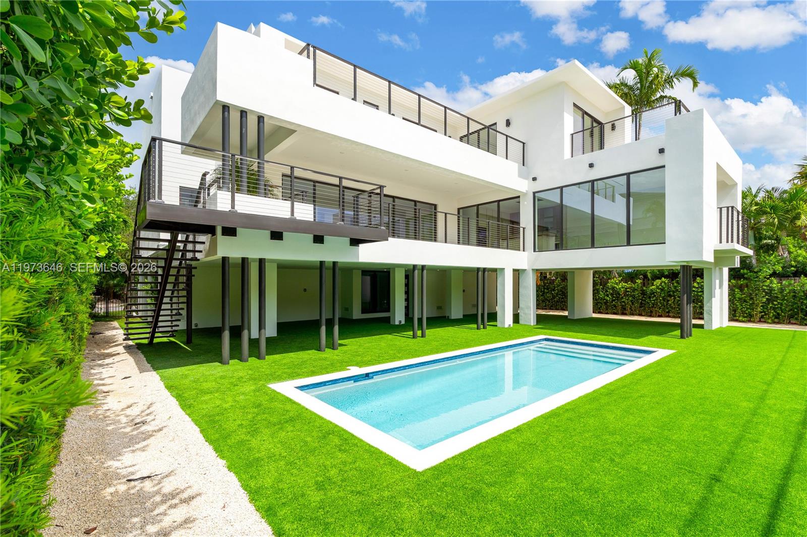 285 Woodcrest Road Key Biscayne, FL 33149 - Photo 42 of 53 a view of an house with backyard and swimming pool