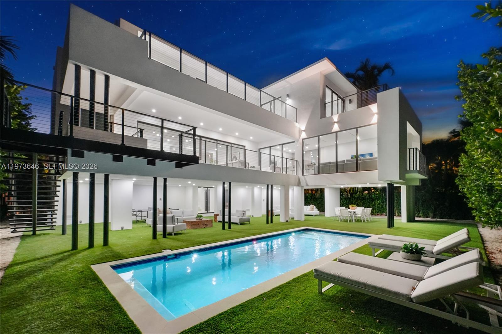 285 Woodcrest Road Key Biscayne, FL 33149 - Photo 43 of 53 a view of a house with pool and chairs