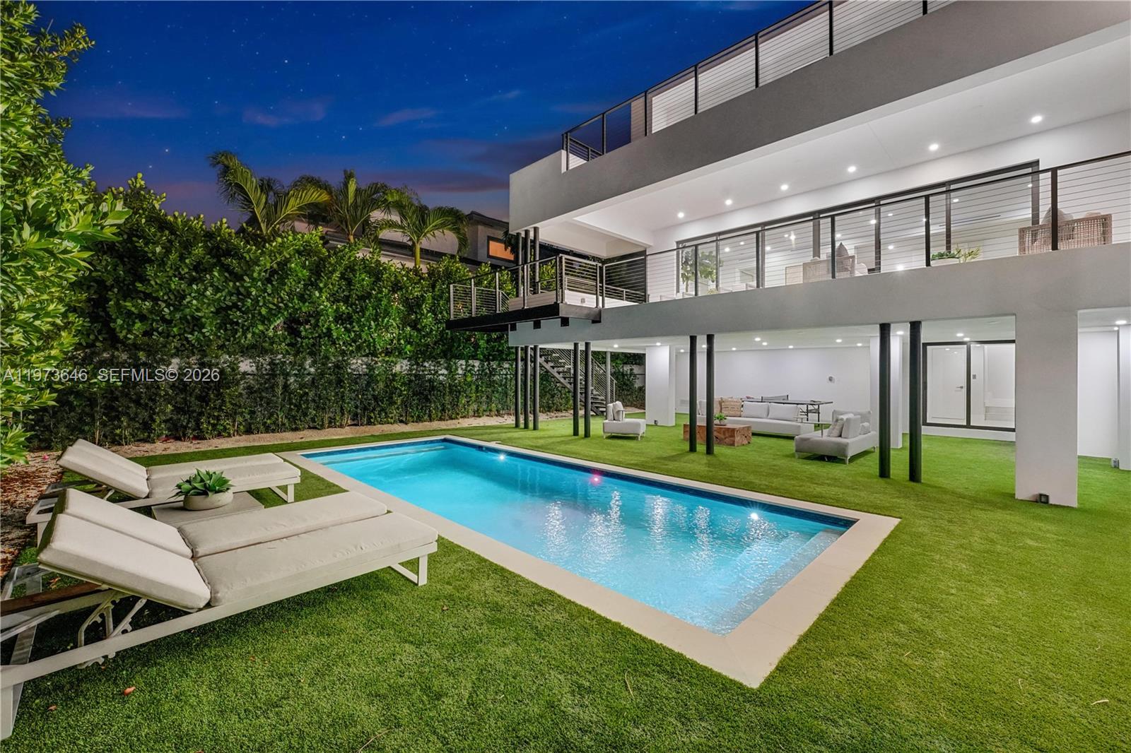 285 Woodcrest Road Key Biscayne, FL 33149 - Photo 44 of 53 a view of a house with pool backyard and chairs