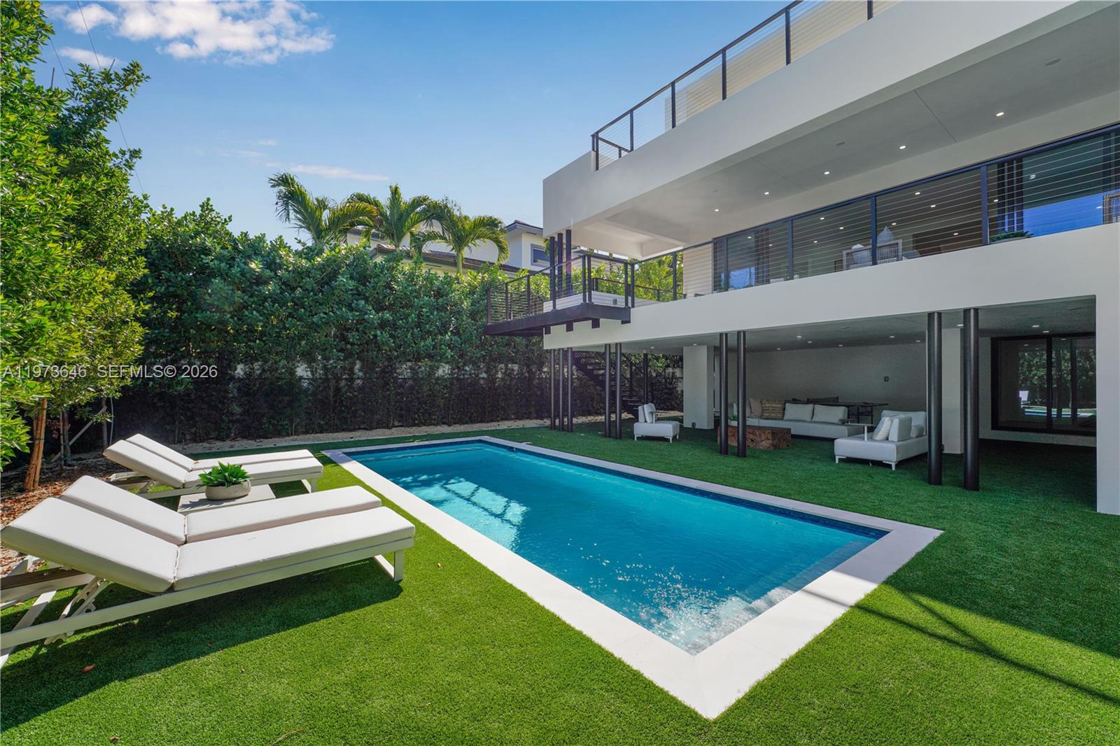 285 Woodcrest Road Key Biscayne, FL 33149 - Photo 7 of 53 a view of a house with pool and chairs