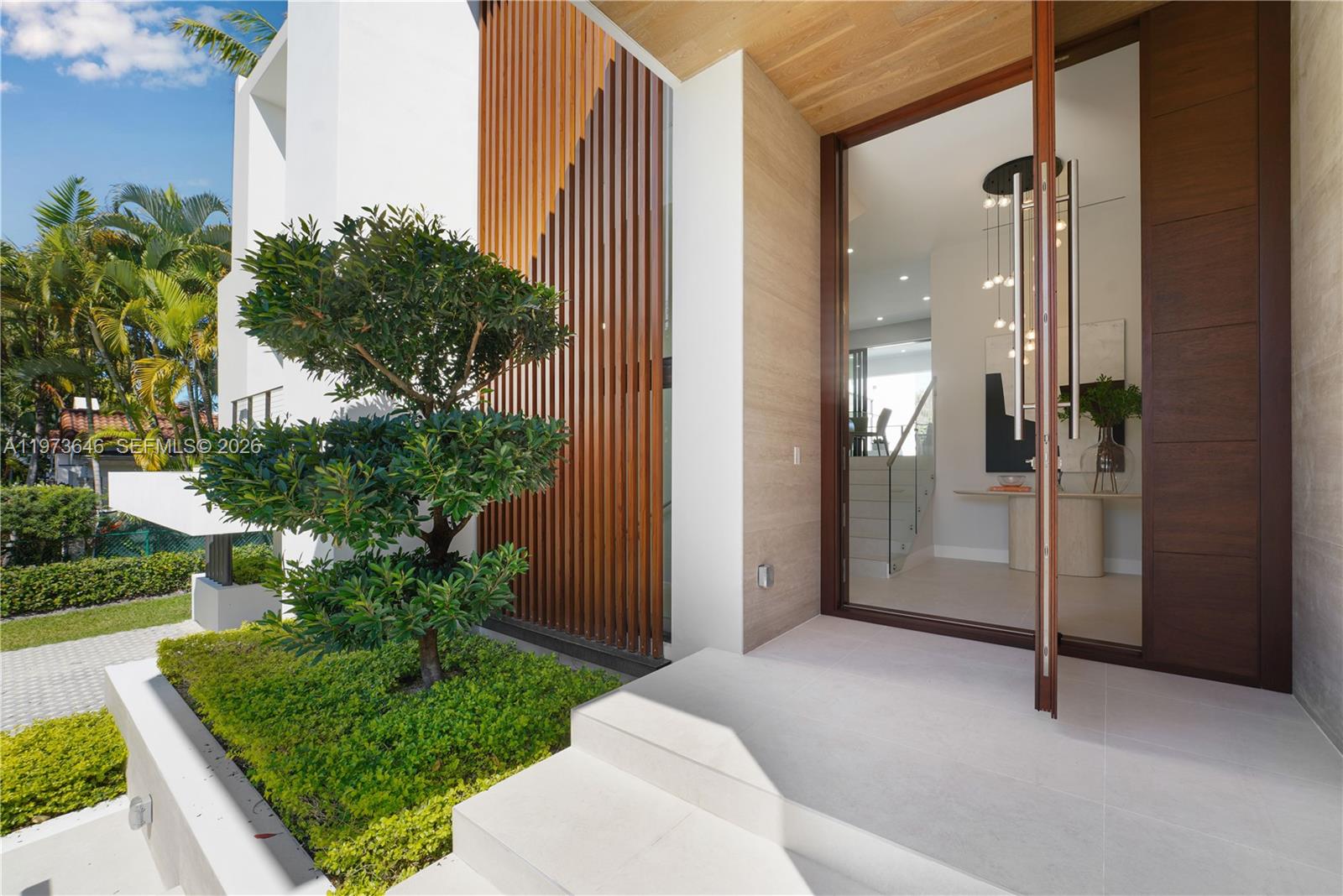 285 Woodcrest Road Key Biscayne, FL 33149 - Photo 8 of 53 a view of a glass door and porch