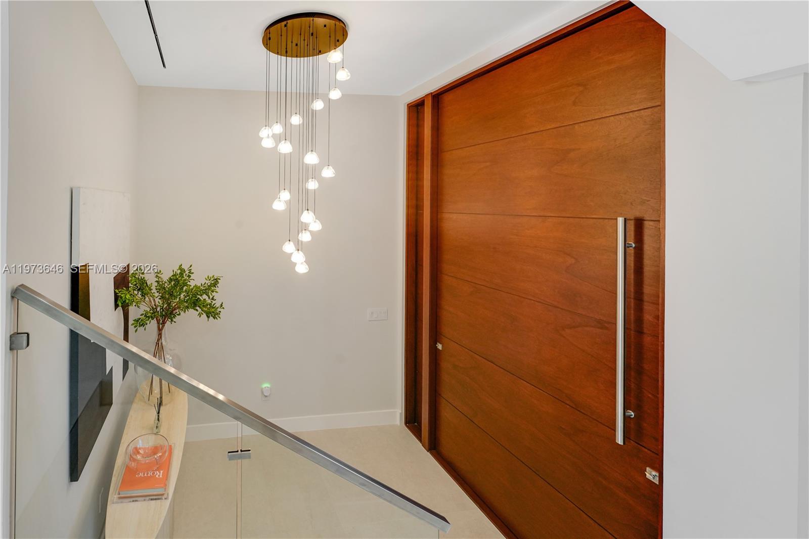 285 Woodcrest Road Key Biscayne, FL 33149 - Photo 10 of 53 a view of a hallway with chandelier