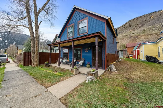 a view of a house with backyard porch and sitting area