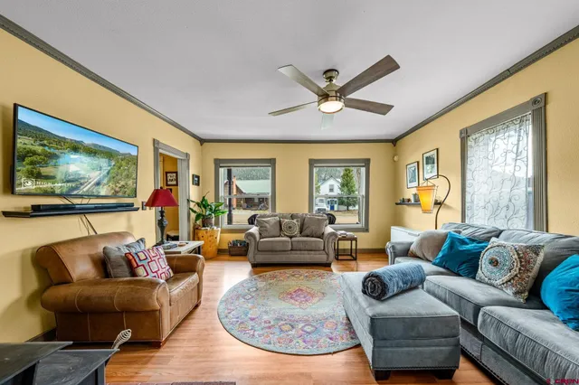 a living room with a bed and a window