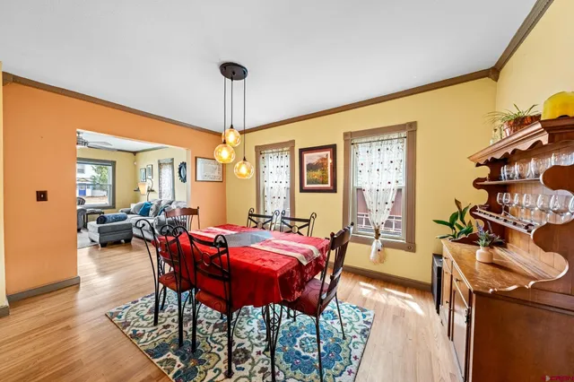 a spacious bathroom with a table chairs and a double vanity