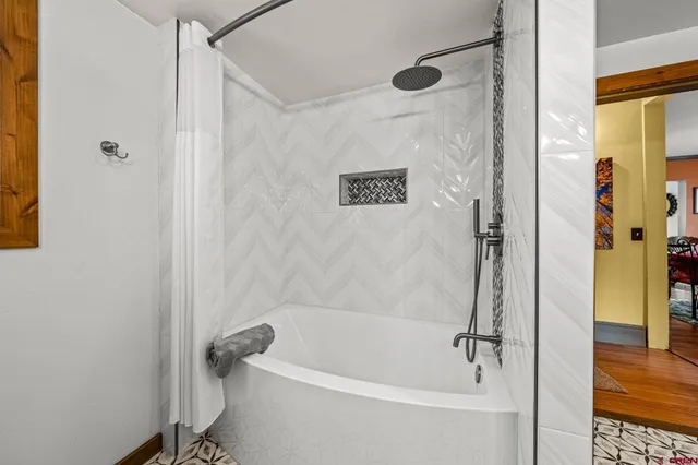 a bedroom with a bed and a mirror