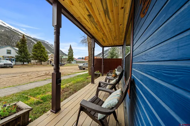a backyard of a house with table and chairs