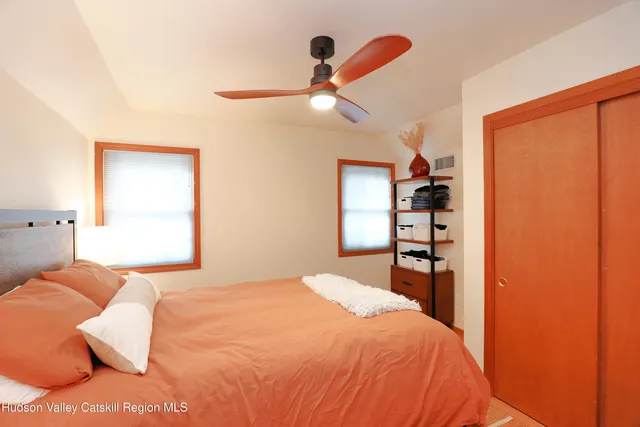 a bedroom with a bed and a window