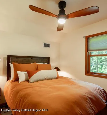 a bed sitting in a bedroom next to a window