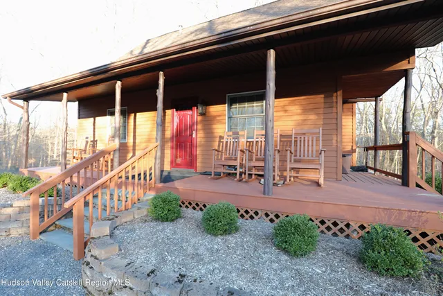 a view of a patio with chairs and floor to ceiling window