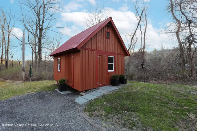 a view of a small house with a yard