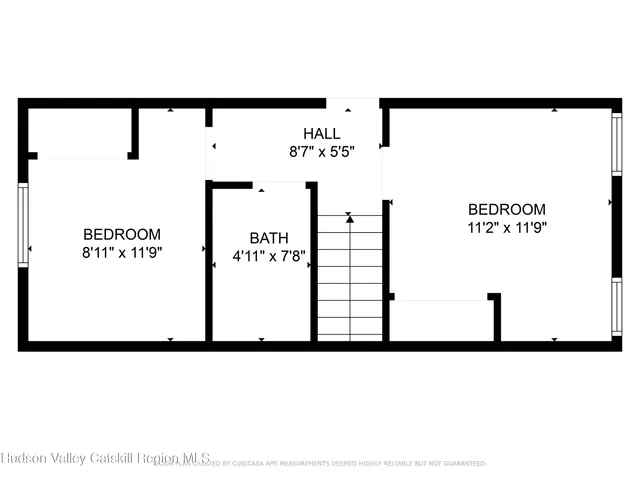 a picture of a wall with a white building