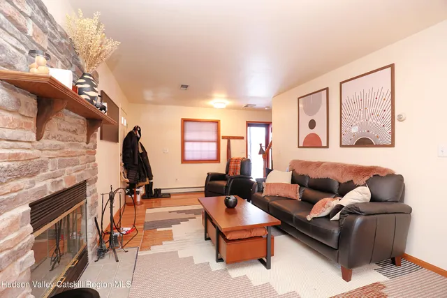 a living room with furniture a fireplace and a flat screen tv