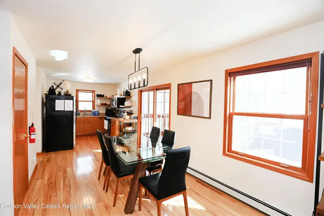 a view of a dining room with furniture window and wooden floor