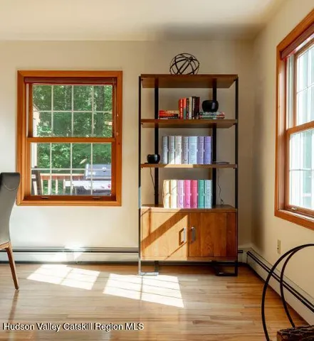 a view of an empty room with window and book shelf