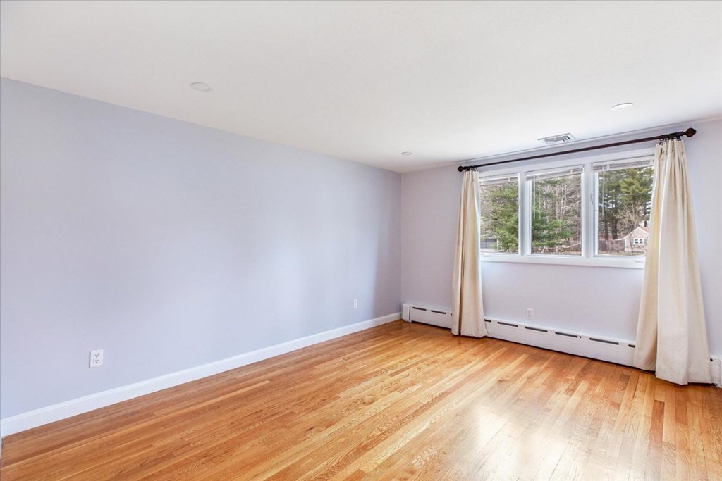 56 James Road Hanover, MA 02339 - Photo 15 of 31 an empty room with wooden floor and windows