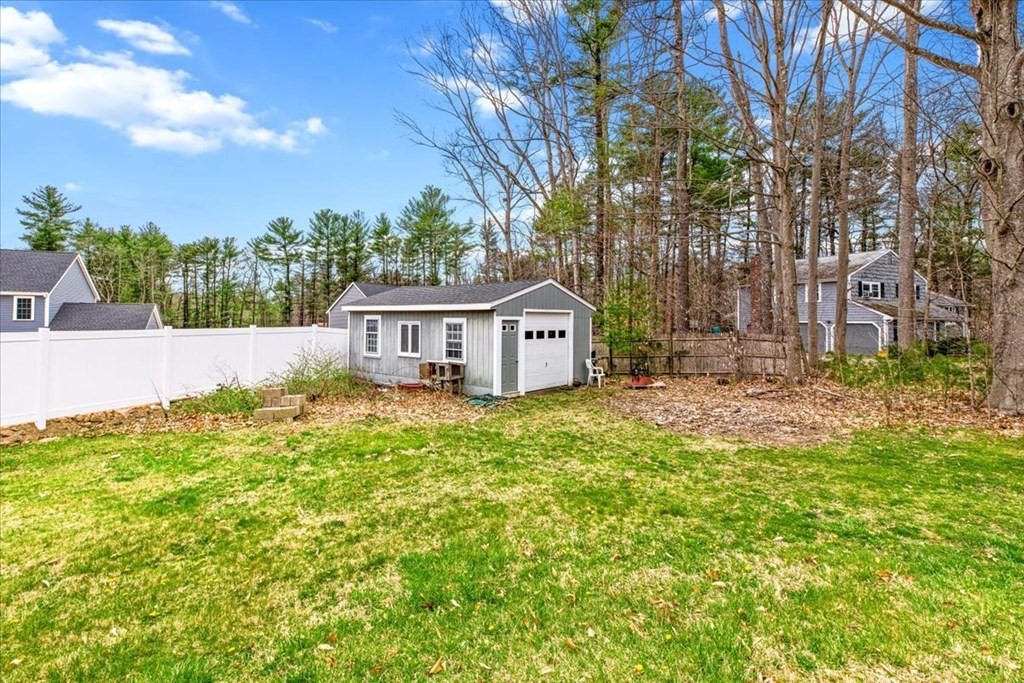 56 James Road Hanover, MA 02339 - Photo 27 of 31 a front view of a house with a garden and trees