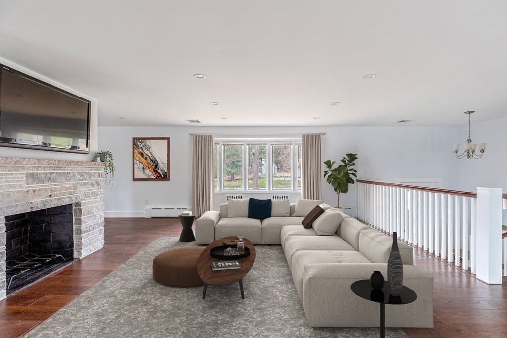56 James Road Hanover, MA 02339 - Photo 3 of 31 a living room with furniture a flat screen tv and a fireplace