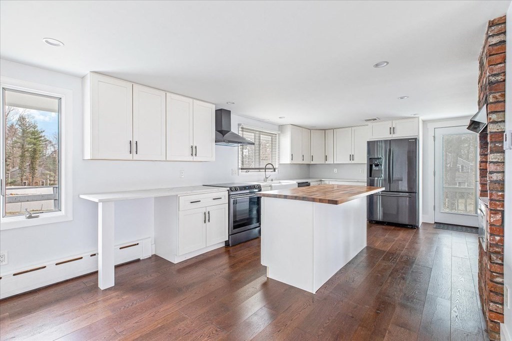 56 James Road Hanover, MA 02339 - Photo 6 of 31 a kitchen with white cabinets and white appliances