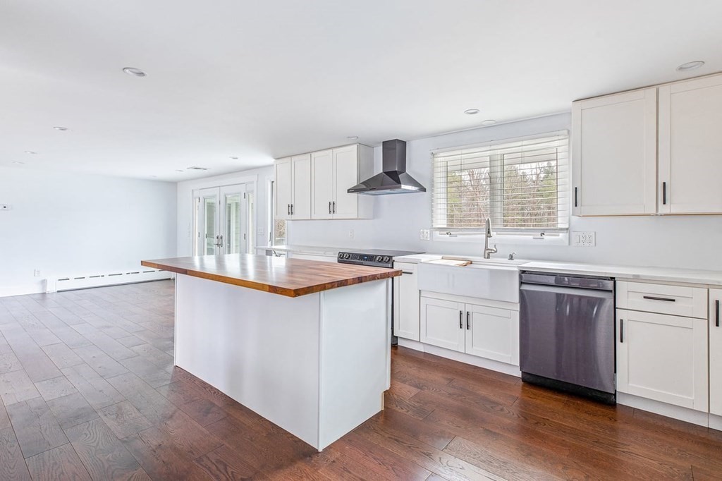 56 James Road Hanover, MA 02339 - Photo 7 of 31 a kitchen with granite countertop white cabinets and white appliances