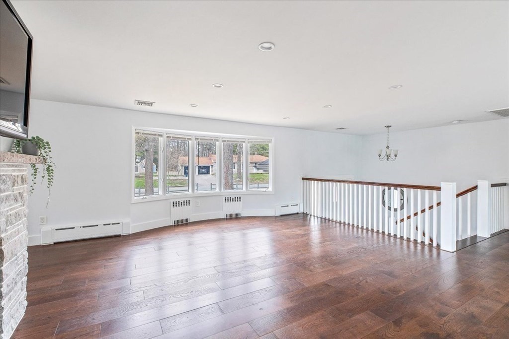 56 James Road Hanover, MA 02339 - Photo 9 of 31 a view of an empty room with wooden floor and a window