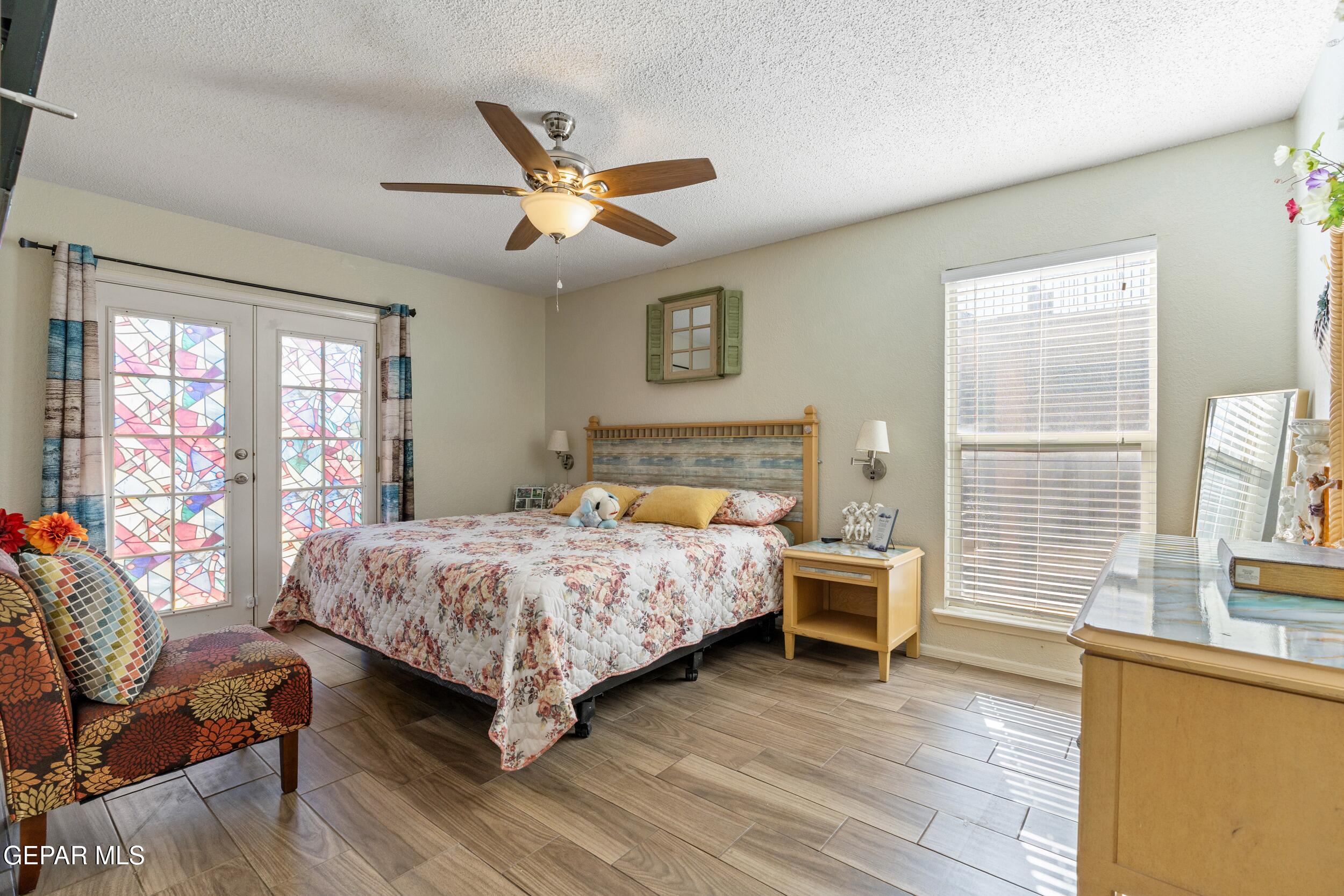 4433 North Stanton Street, Unit P358 El Paso, TX 79912 - Photo 11 of 19 a bedroom with a bed and wooden floor