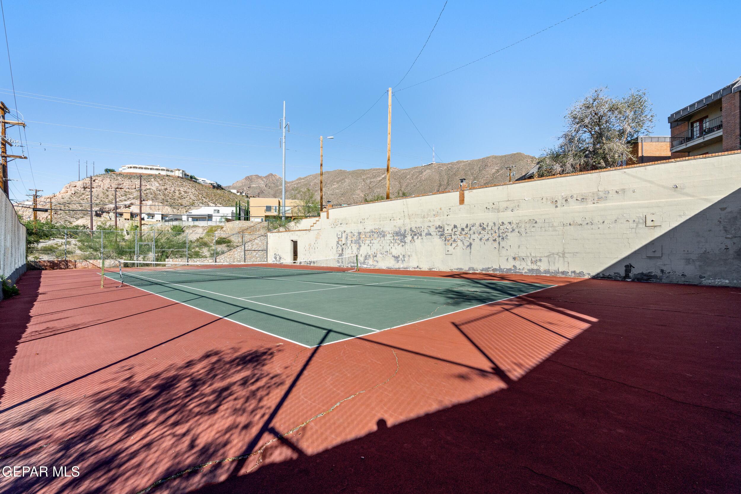 4433 North Stanton Street, Unit P358 El Paso, TX 79912 - Photo 19 of 19 a view of a tennis ground with large trees
