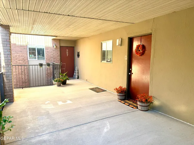 a view of a bedroom with a bed and glass door