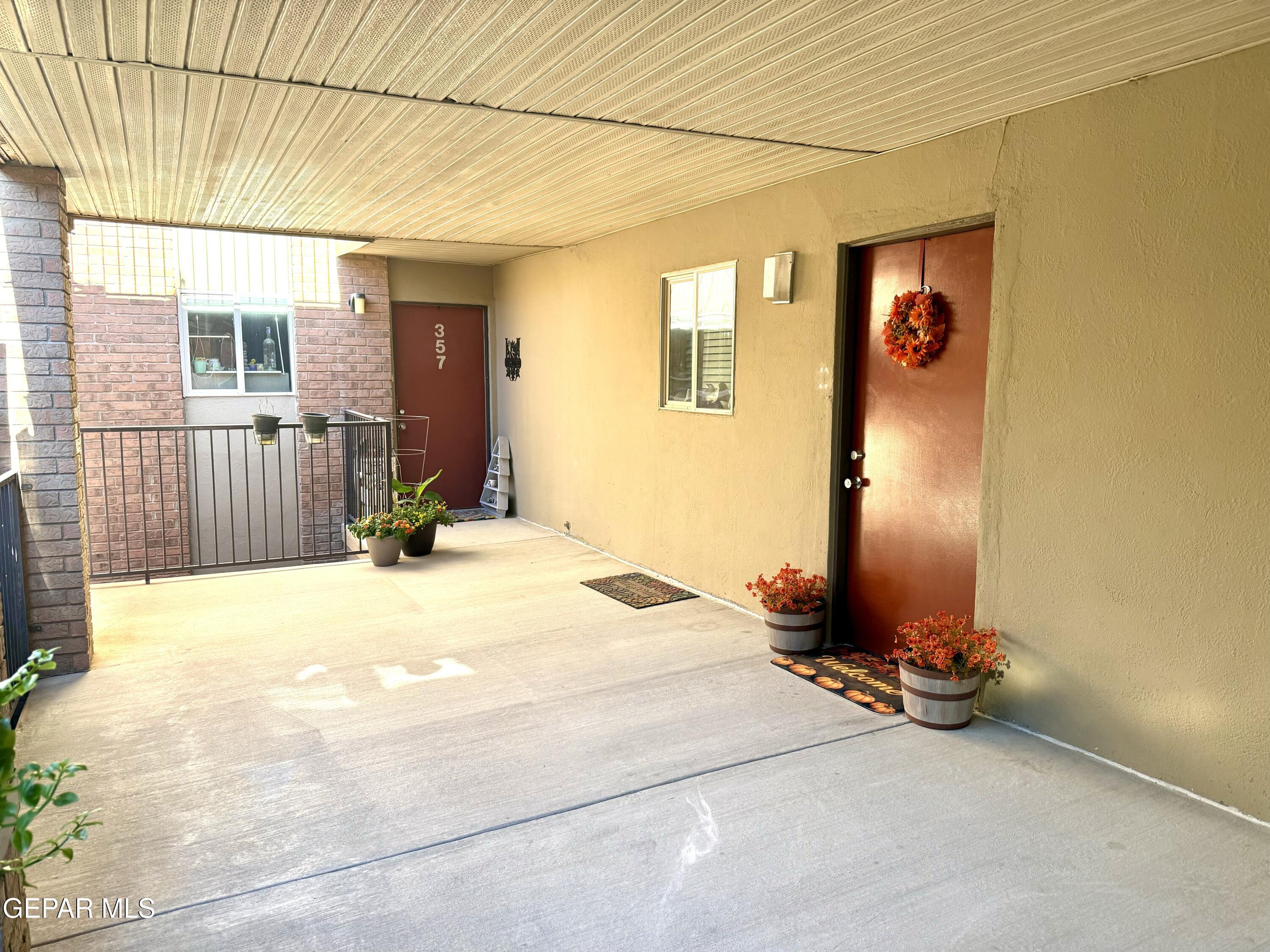 4433 North Stanton Street, Unit P358 El Paso, TX 79912 - Photo 2 of 19 a view of a bedroom with a bed and glass door