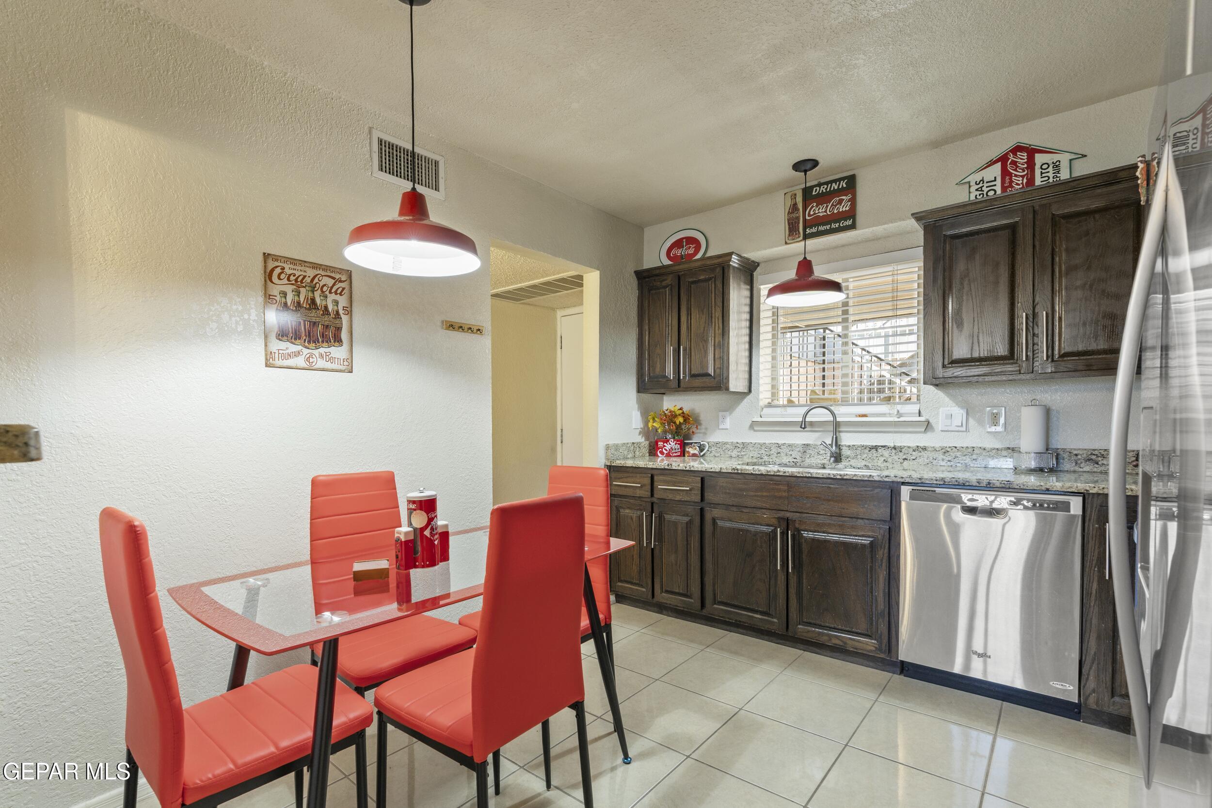 4433 North Stanton Street, Unit P358 El Paso, TX 79912 - Photo 5 of 19 a dining table chair a chandelier and entryway