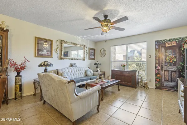 a living room with furniture and a floor to ceiling window
