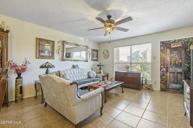 a living room with furniture and a floor to ceiling window