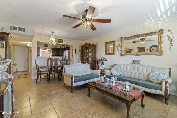 a living room with furniture and kitchen view