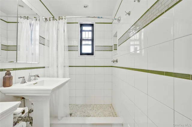 a bathroom with a shower and a sink