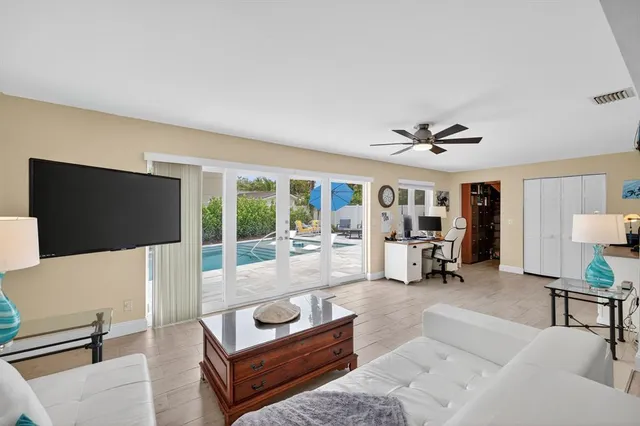 a living room with furniture and a wooden floor