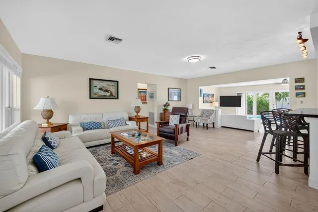 a living room with furniture kitchen view and a table