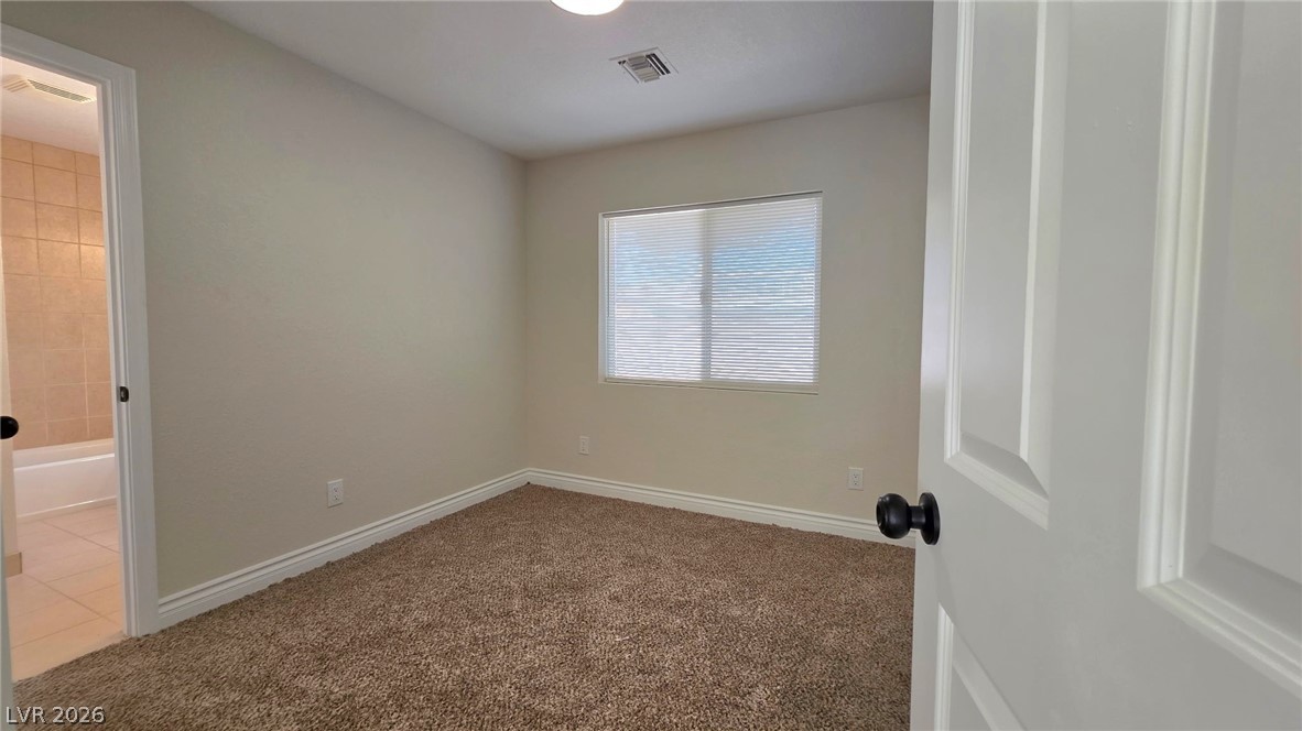 2155 Athol Way Laughlin, NV 89029 - Photo 12 of 19 Well-lit room with plush carpet, offering a versatile space for rest or productivity.