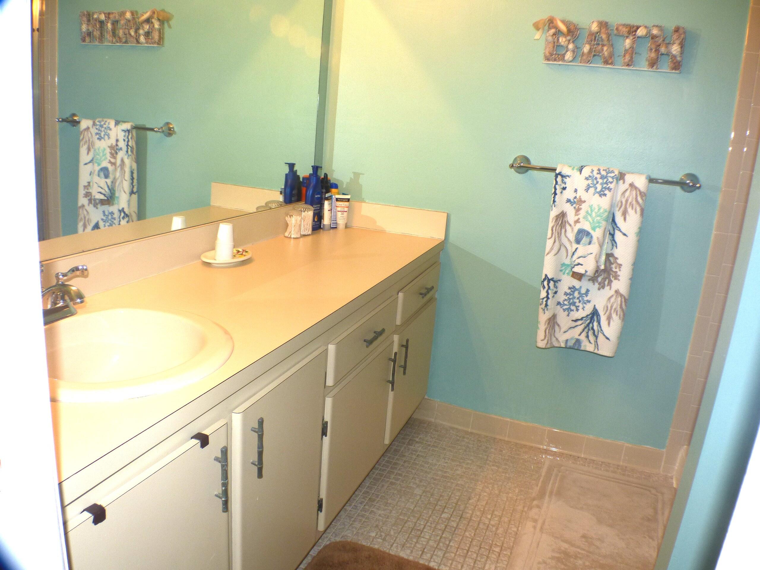 2686 Northwest 7th Court, Unit C Delray Beach, FL 33445 - Photo 11 of 33 a bathroom with a sink and a mirror