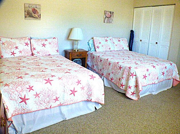 2686 Northwest 7th Court, Unit C Delray Beach, FL 33445 - Photo 13 of 33 a bedroom with three beds and lamps