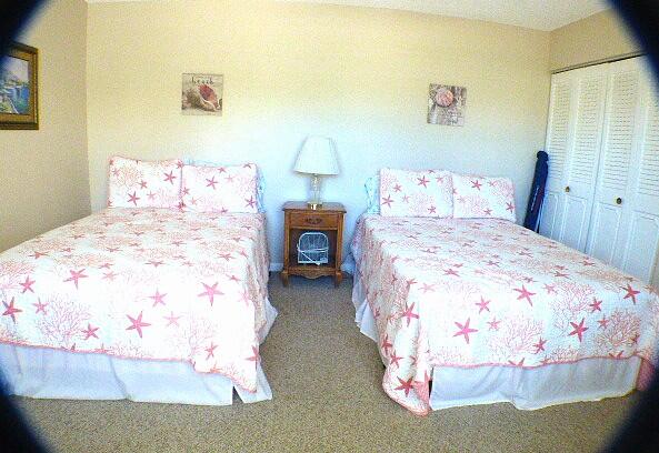 2686 Northwest 7th Court, Unit C Delray Beach, FL 33445 - Photo 14 of 33 a bedroom with a bed and a table