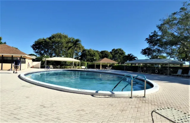a view of a swimming pool with a patio