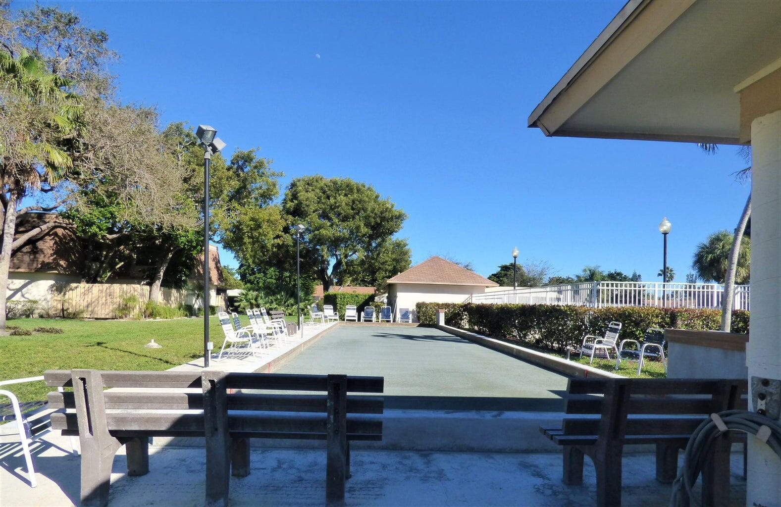 2686 Northwest 7th Court, Unit C Delray Beach, FL 33445 - Photo 24 of 33 a view of a patio with table and chairs and potted plants
