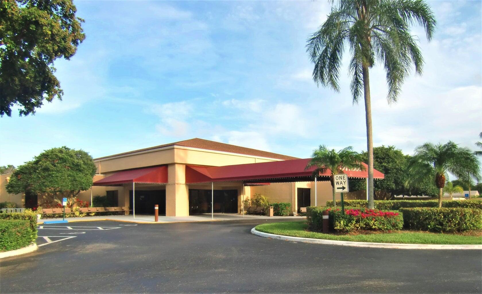 2686 Northwest 7th Court, Unit C Delray Beach, FL 33445 - Photo 29 of 33 a front view of house with yard and green space