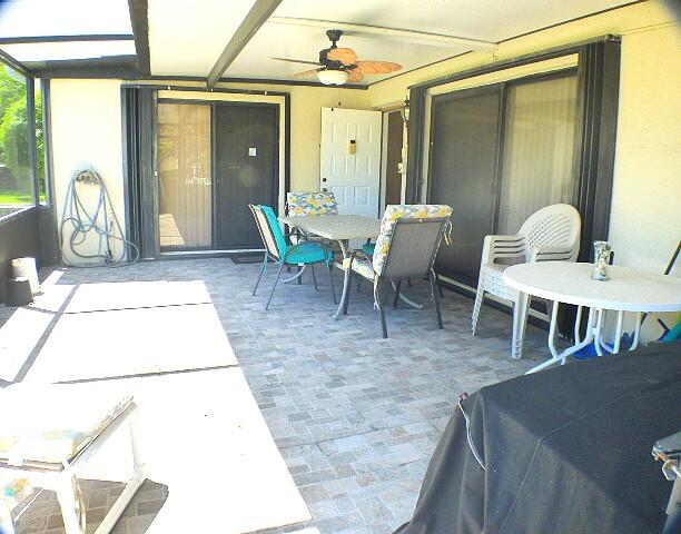 2686 Northwest 7th Court, Unit C Delray Beach, FL 33445 - Photo 3 of 33 a living room with furniture a window and potted plants