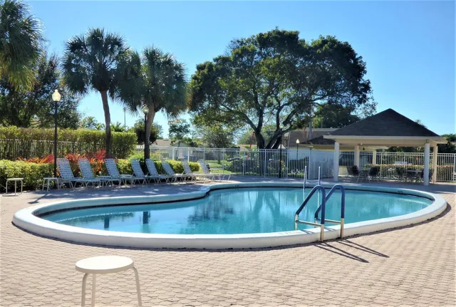 a view of a swimming pool with a yard